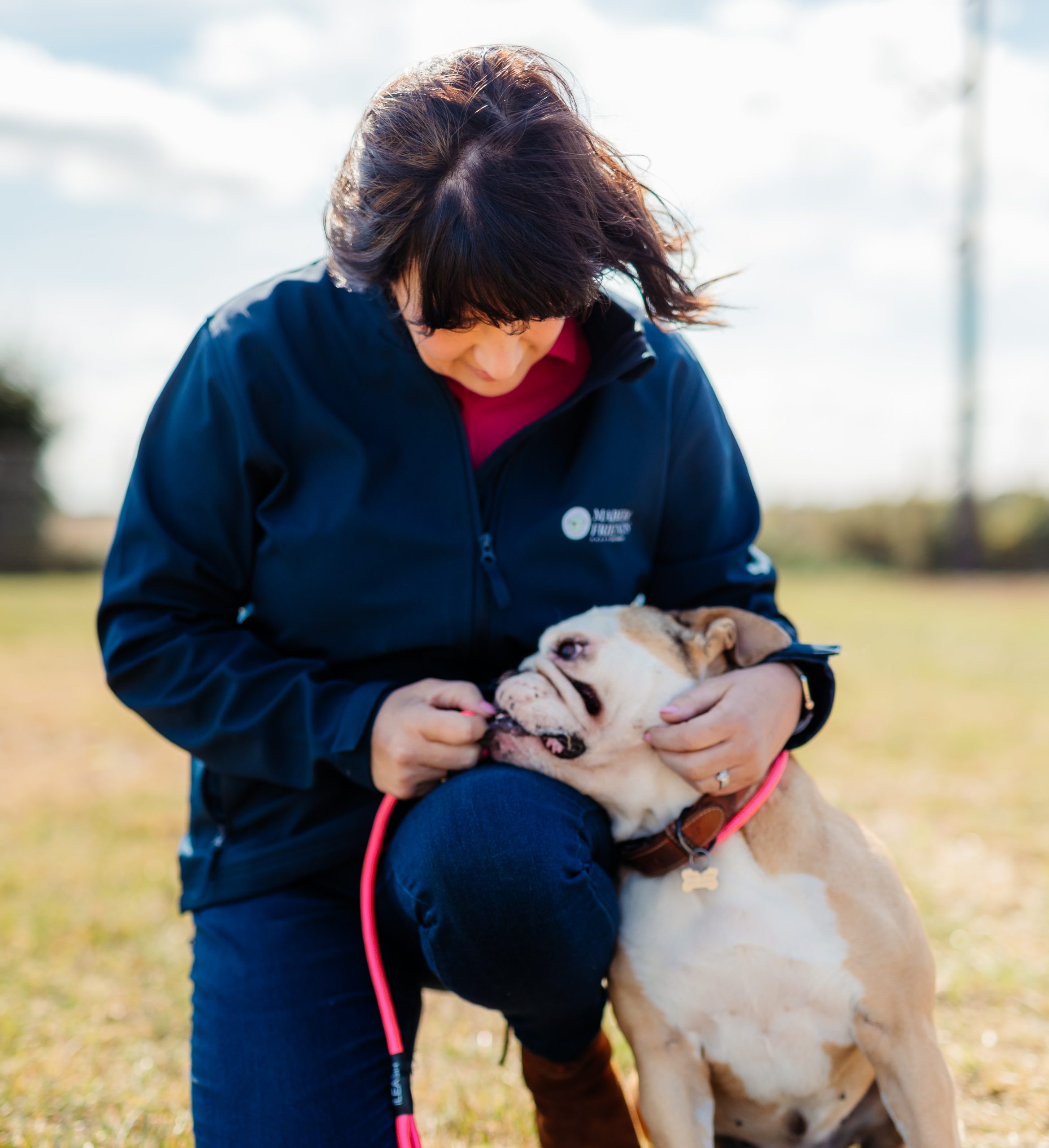 a woman petting a dog