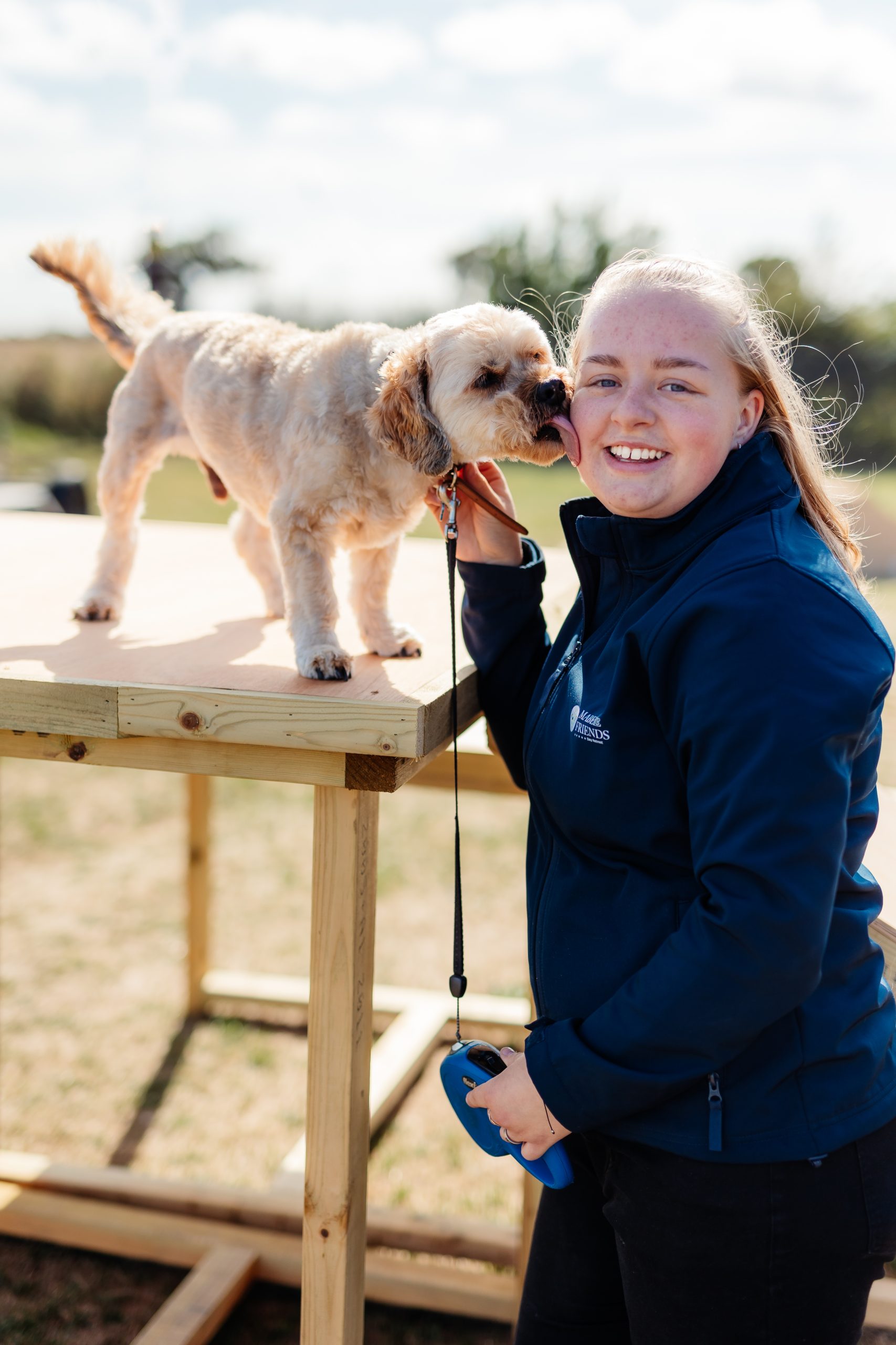 a dog licking a smiling woman